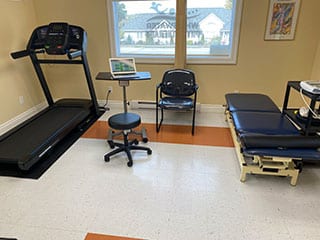 View of clinic interior including treadmill and treatment table