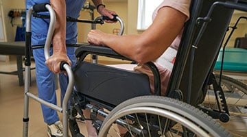 Patient moving from wheelchair to a two stage walker