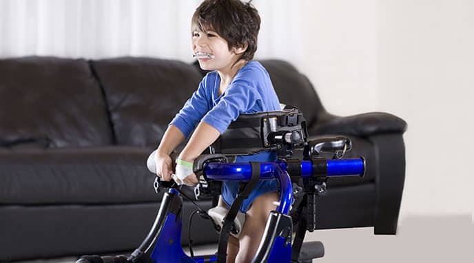 Young boy using a gait trainer